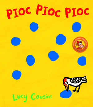 Photo shows a yellow page with red title of Pioc Pioc Pioc and various small blue dots to show woodpecker marks and a small graphic of a woodpecker.